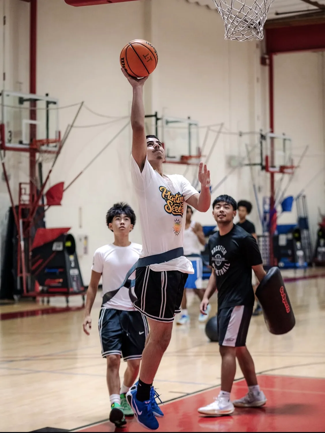 The U athlete finishing a finger roll at the rim