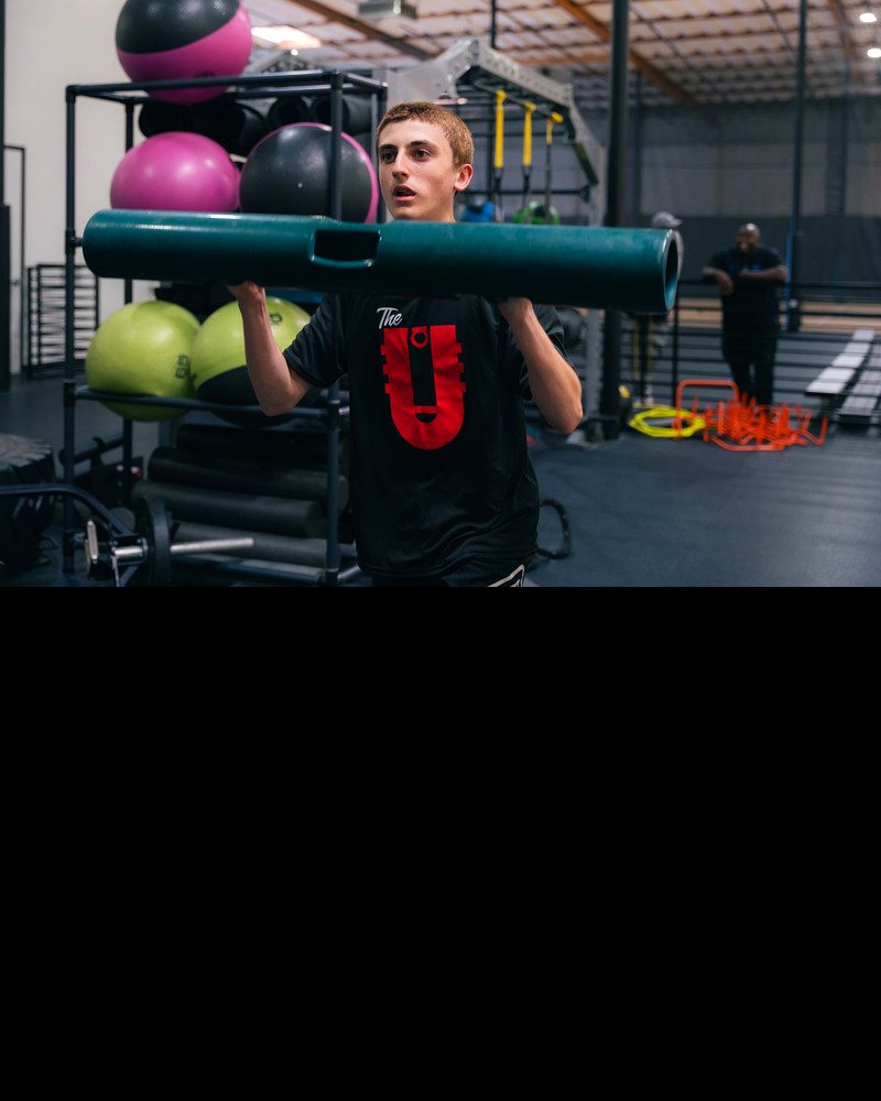 The U athlete in a strength session with a weighted bar