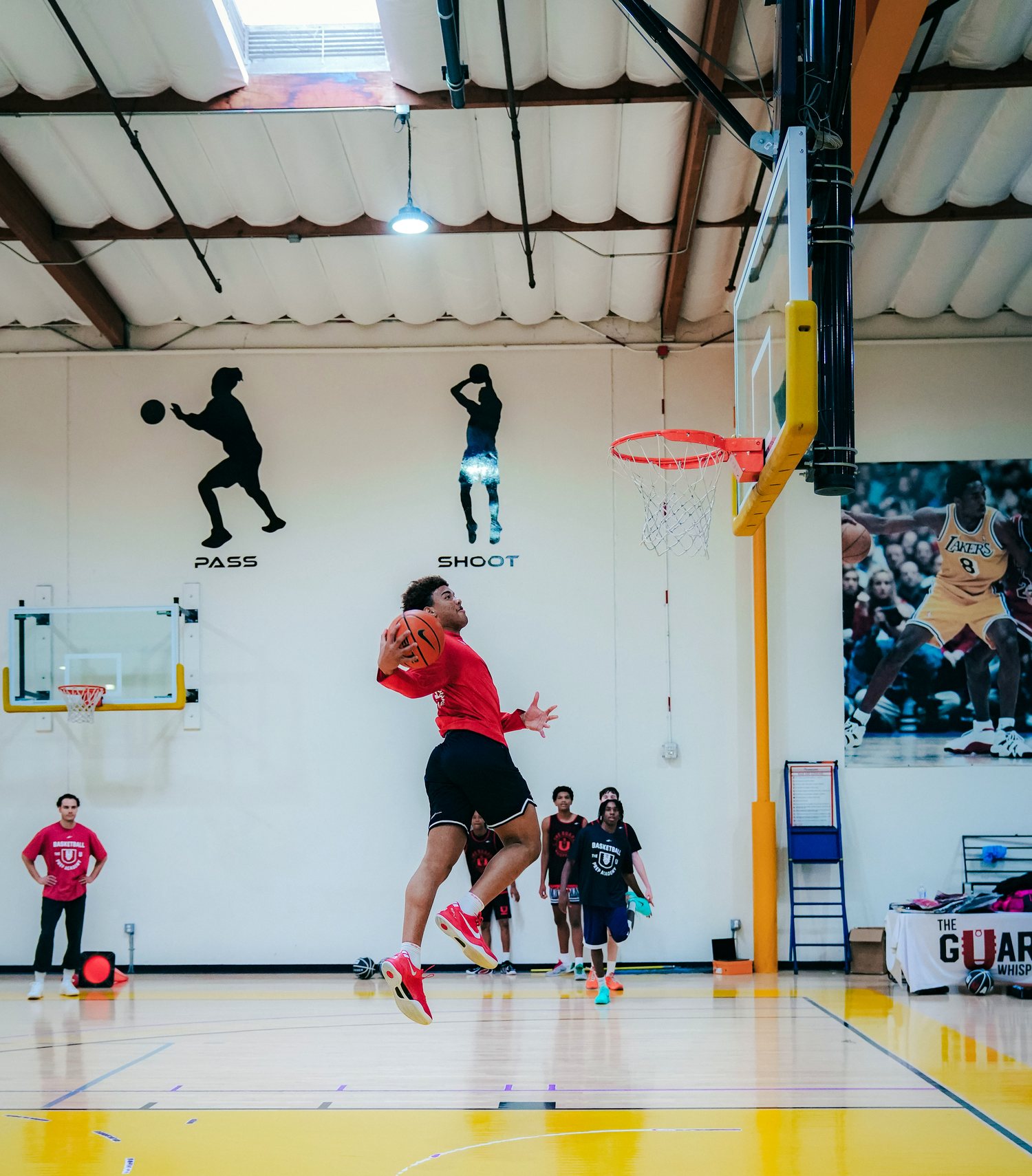 The U athlete finishing at the rim during training in The Dojo